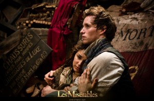 Eddie Redmayne as Marius and Samantha Barks as Éponine. In this scene, Éponine has come from outside the barricades where she was shot. The song performed is 'Little Fall of Rain'. This is a very moving moment in the film.